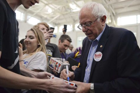 Bernie Sanders signs Bernie Sanders action figures at a visit earlier this year.   John Hamilton | Staff Photographer