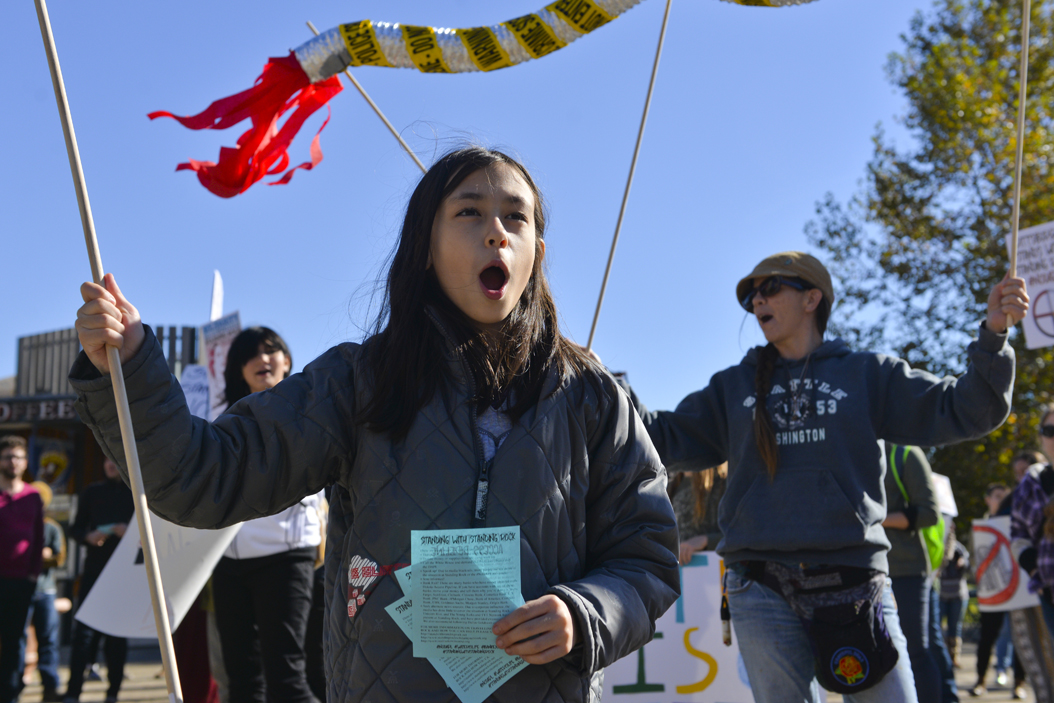 Raven Dean, age 9, came to the protest with her father, Chuck Dean, to publicize the Dakota Access Pipeline because "the government is trying to hide [it]." Stephen Caruso | Senior Staff Photographer