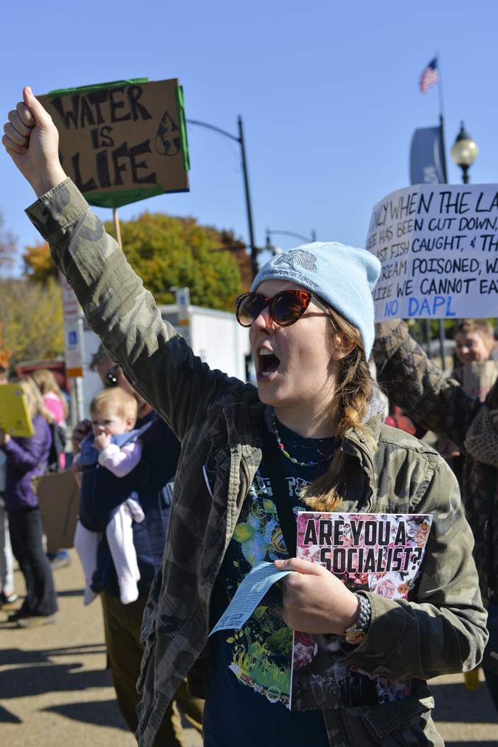 Maggie Repko, 24, an Edgewood resident, came out to the protest because with "grandmas on the frontline" in North Dakota, she felt it was the least she could do. Stephen Caruso | Senior Staff Photographer