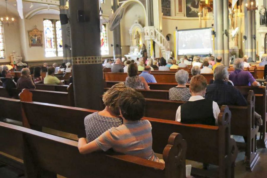 Families at St. Stanislaus Kostka Church listen to a live feed of Pope Francis speak on Sunday.  Theo Schwarz | Senior Staff Photographer