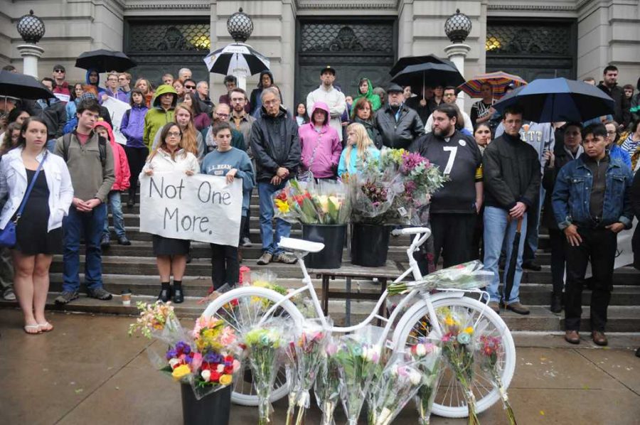 A crowd gathers outside Carnegie Music Hall to honor Susan Hicks, who lost her life in a cycling accident on Friday.  Wenhao Wu | Staff Photographer