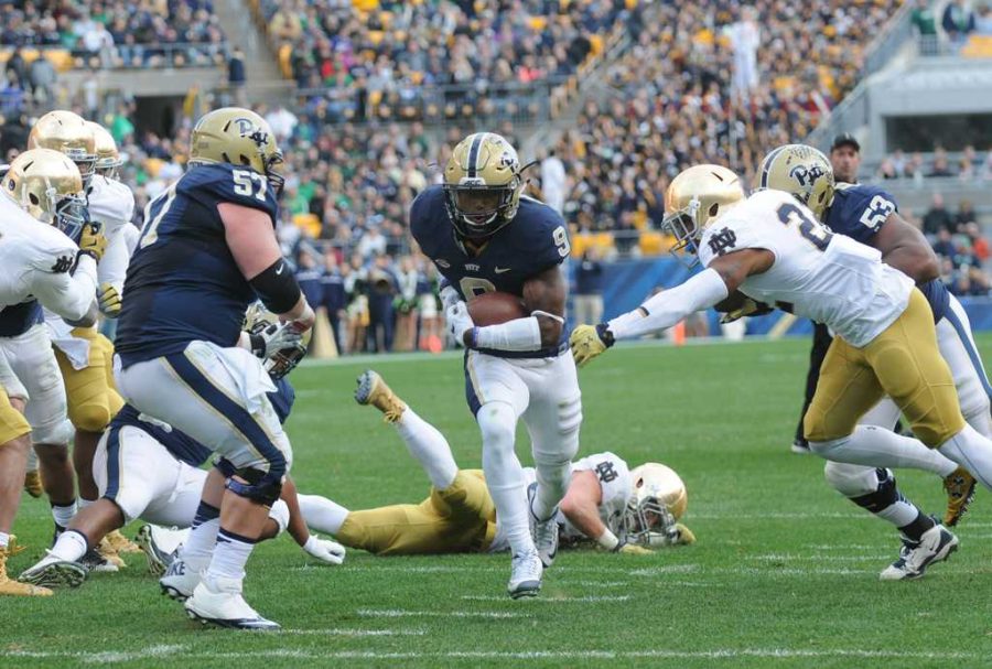 Jordan Whitehead runs in the first of his two touchdown on Saturday.  Heather Tennant | Staff Photographer