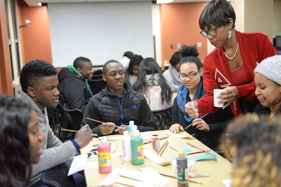 During My Cry in the Dark, an event addressing mental health in the black community, Delta Sigma Theta member Shelleah Jackson instructs a table creating bookmarks with positive messages.  Will Miller | Staff Photographer 
