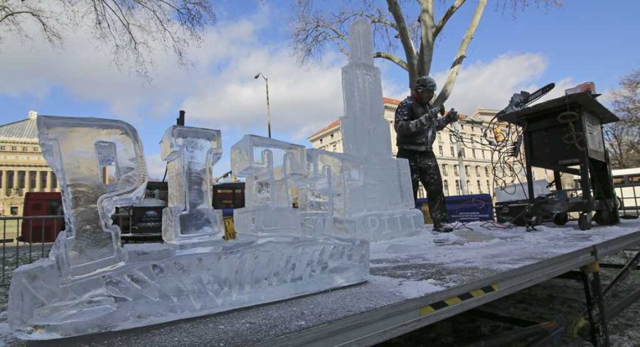 Richard Bubin, owner of Ice Creations, carved the Cathedral of Learning and other sculptures out of a block of ice in front of the William Pitt Union on Monday.  Theo  Schwartz | Senior Staff Photographer.  