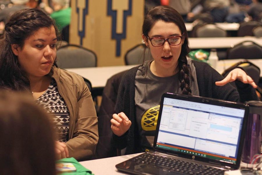 Emilee Betz (right) explaining her teams app to a judge. Emily Brindley for the Pitt News