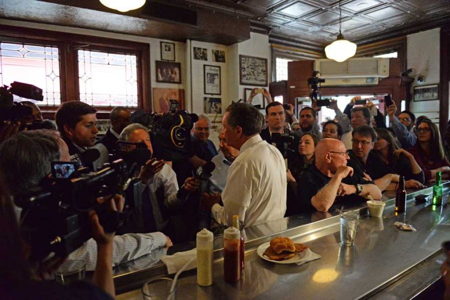 Governor Kasich views the pictures in the Original Oyster House in Market Square. Alex Nally | Staff Photographer