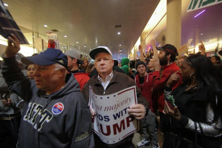 Trump supporter exits the David Lawrence Convention Center amidst protesters and other supporters on April 14, 2016. Theo Schwarz | Senior Staff Photographer