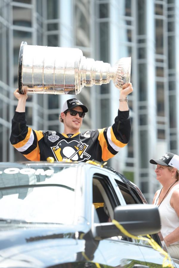 Pittsburgh Penguins captain Sidney Crosby hoists the Stanley Cup in the air. Kate Koenig | Visual Editor