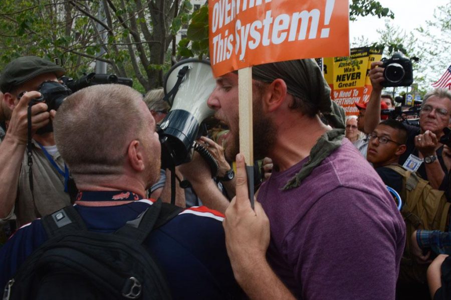 An communist protestor starts to yell at a Trump supporter who had been interrupting a speech with his megaphone. Stephen Caruso | Contributing Editor