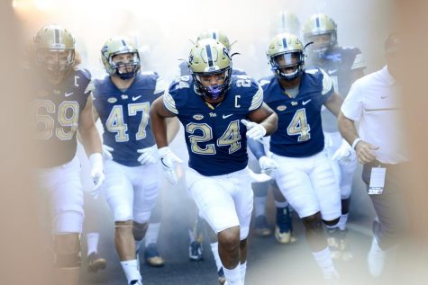 James Conner (24) leads the team out of the tunnel prior to kickoff.  Jeff Ahearn | Senior Staff Photographer