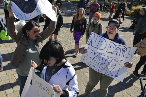 Anna Jacob (left), Jackie Sciulli (center) and Gabby Sevilla (right) are protesting because "the land and the water are sacred." They accuse the companies building the pipeline, not the protesters arrested in North Dakota, of trespassing. Stephen Caruso | Senior Staff Photographer