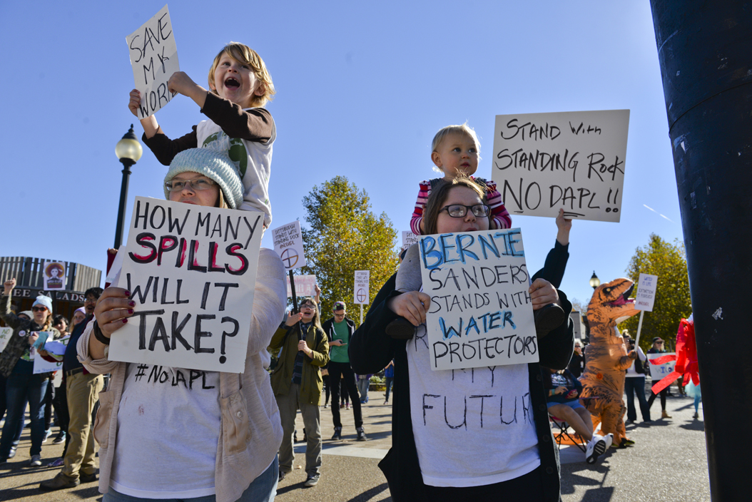 Chelsea Stone (bottom left) came to the protest with her three kids, Lily (top right), age 2, Johnnie (top left), age 4, and Skye, (bottom right), age 15. Stone brought her kids to the protest to raise awareness within them about the issues affecting "their world." Stephen Caruso | Senior Staff Photographer