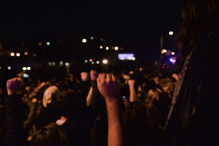 A protester raises a fist in solidarity during a moment of silence on the Birmingham Bridge for victims of hate crimes following the election of Donald Trump. Stephen Caruso | Online Visual Editor