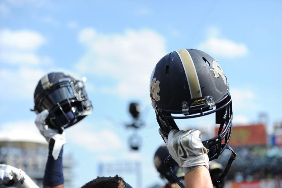Pitt football players raise their helmets skyward during a game at Heinz Field last fall. John Hamilton | Visual Editor