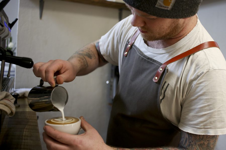 Redhawk Coffee owner Braden Walter pours a latte. John Hamilton | Visual Editor