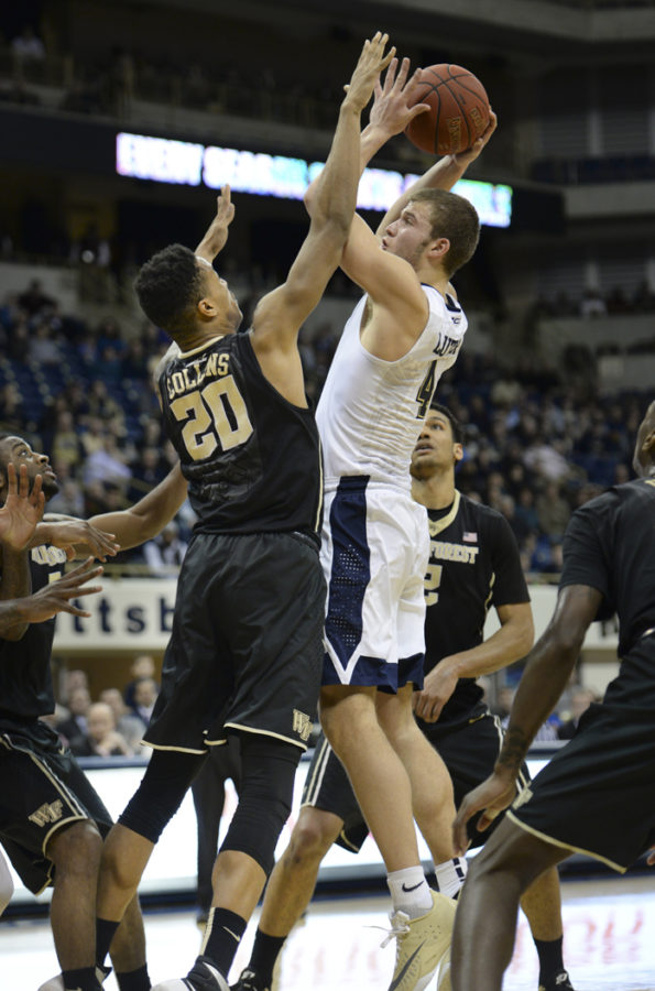 John Collins tries to block Ryan Luther during a game last February. John Hamilton | Visual Editor