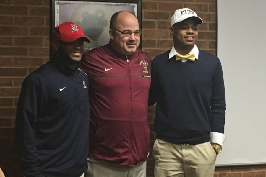 Paris Ford (right) poses Wednesday with his former Steel Valley High School head coach, Rod Steele, and former teammate, Dewayne Murray, after signing his National Letter of Intent. Dominic Campbell | For The Pitt News 