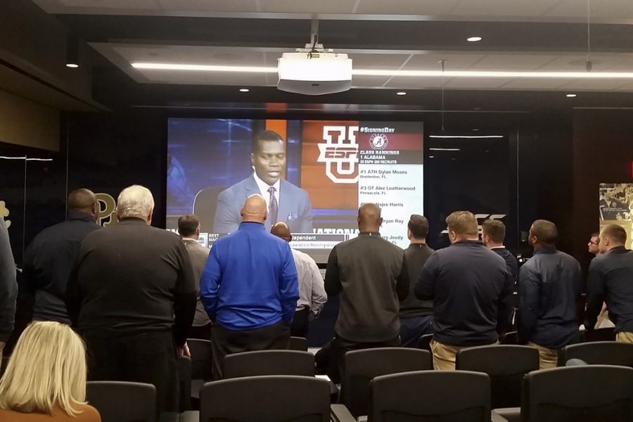 Pitts football coaching staff gathers in the team room to watch running back A.J. Davis announce his college decision live on ESPN2 Wednesday afternoon. Steve Rotstein | Contributing Editor