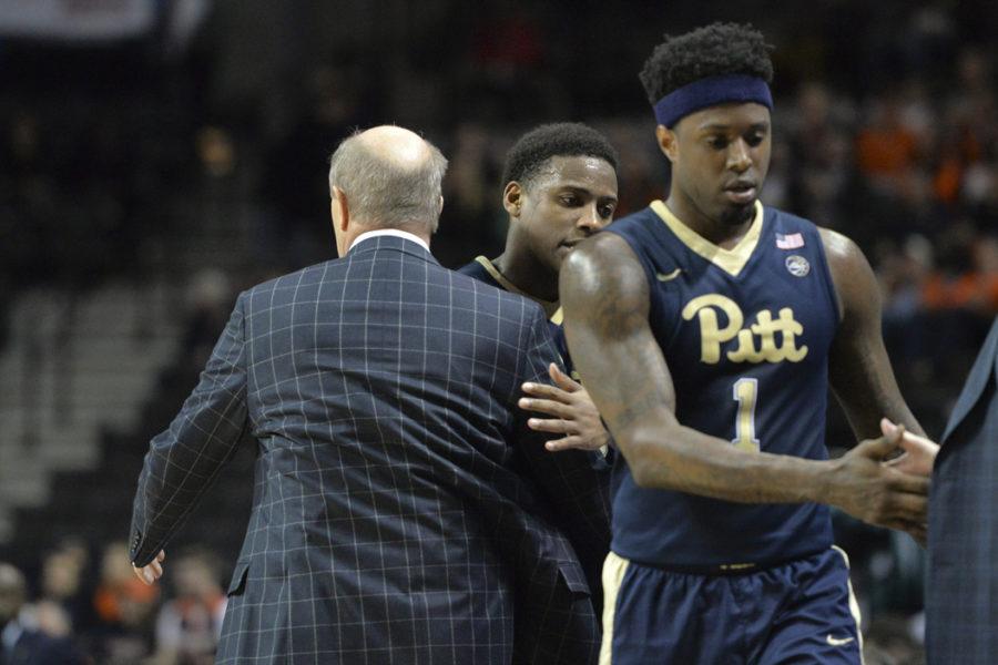 Pitt head coach Kevin Stallings consoles seniors Jamel Artis and Chris Jones after taking them out of what may have been the final game of their college careers, a 75-63 loss vs. No. 21 Virginia in the second round of the ACC Tournament. John Hamilton | Visual Editor