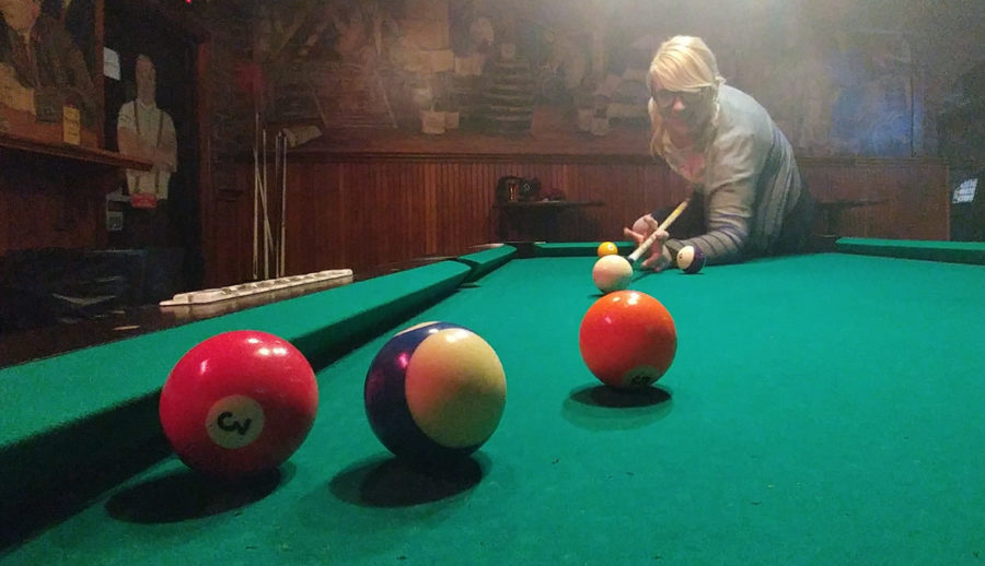 Opinions editor Amber Montgomery 
preparing to take a shot at the pool table at Bootleggers. Stephen Caruso | Assistant Visual Editor
