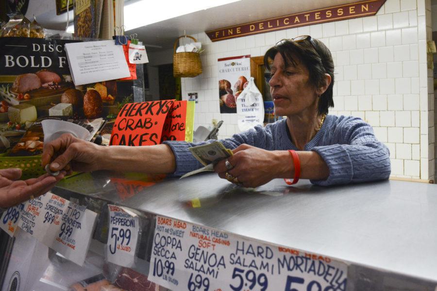 Co-owner of Groceria Merante, Filomena Merante, interacts with a customer over the deli counter in March. She says the store thrives in the summer, even with less students around. (TPN File Photo)