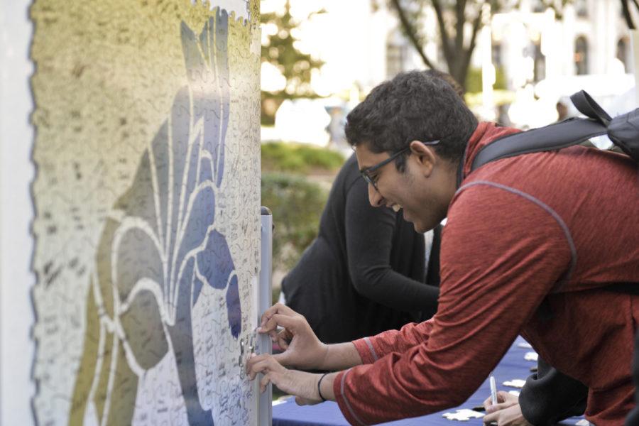 A student adds his name to a panther mosaic at a Year of Diversity event in October 2016. (Photo by Kyleen Considine | Senior Staff Photographer)