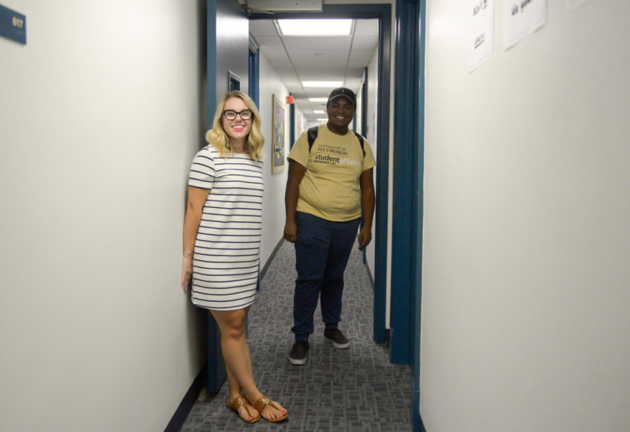 Sejla Jukic (Left) and John Talley (Right), both RAs at Holland, stand at the door that separates the North side and South side of Holland. (Photo by Wenhao Wu | Assistant Visual Editor)