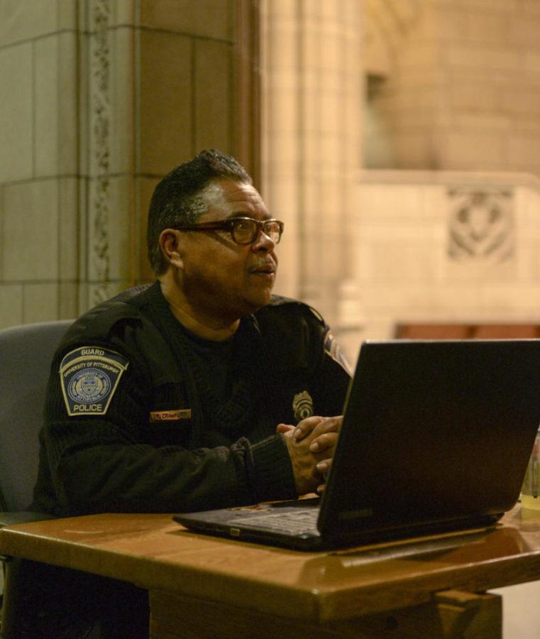 Russell Crawford, a security guard at the Cathedral of Learning, keeps the Cathedral safe at night. (Photo by Wenhao Wu | Assistant Visual Editor)