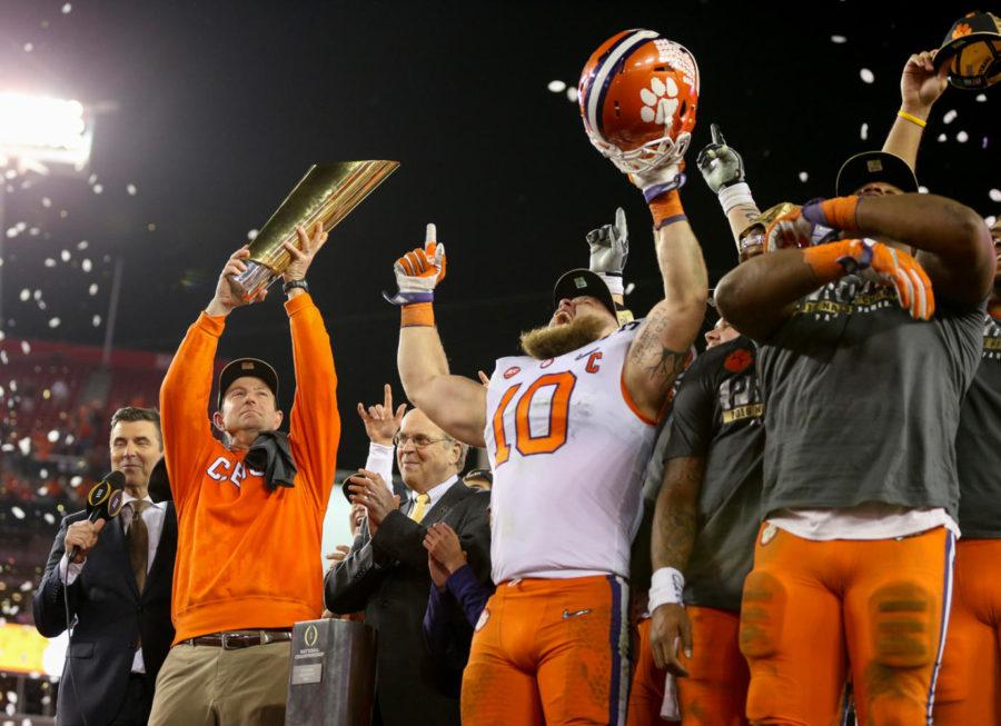 Clemson+Tigers+head+coach+Dabo+Swinney%2C+left%2C+holds+the+College+Football+Playoff+National+Championship+trophy+while+he+and+his+team+celebrate+their+35-31+win+over+the+Alabama+Crimson+Tide+Monday%2C+Jan.+9%2C+2017+in+Tampa%2C+Fla.+%28Loren+Elliot%2FTampa+Bay+Times%2FTNS%29