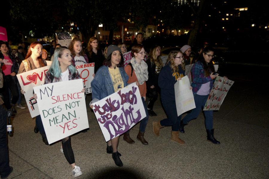Students march through the streets of Oakland Tuesday during Take Back the Night. (Photo by Isabelle Glatts | Staff Photographer)