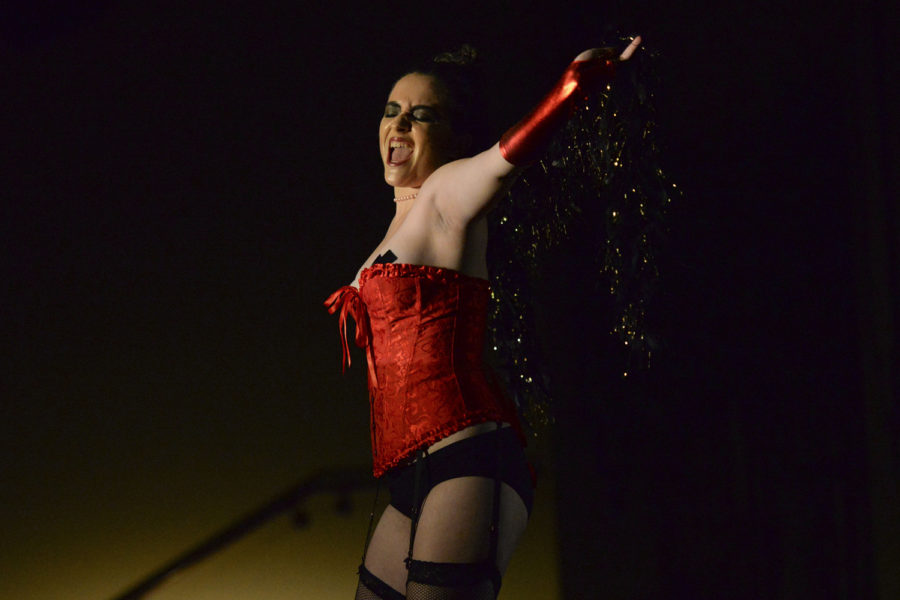 Delena Obermaier, senior, sings at the annual live production of the Rocky Horror Picture Show, the 1975 musical comedy that pushes boundaries, sexuality-wise. (Photo by Sarah Cutshall | Staff Photographer)