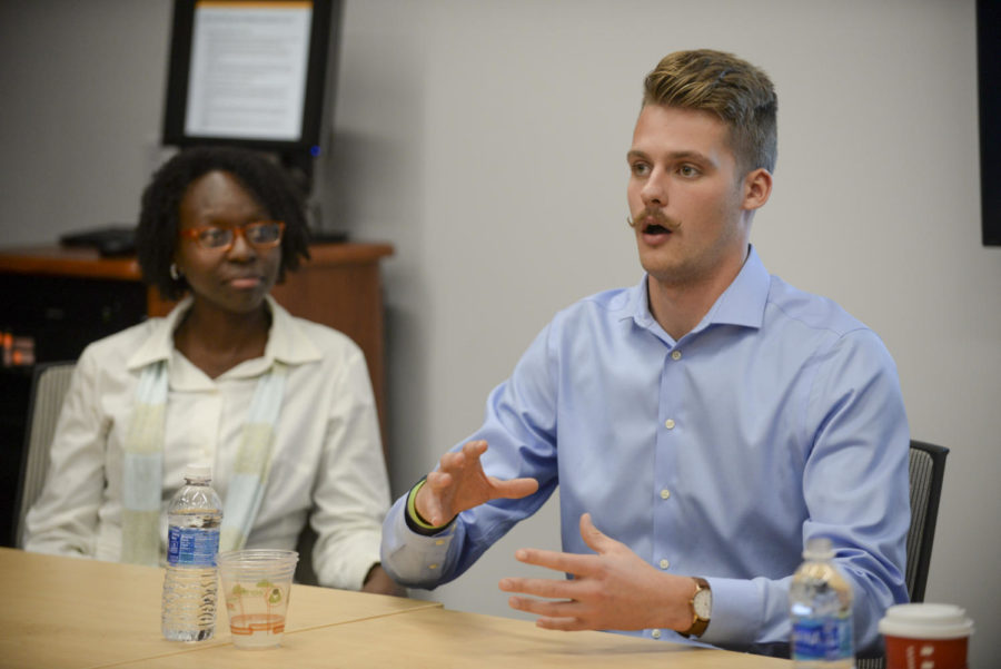Ian Troost (right), a former Pitt football player, and LaTonya Sharif, athletic director at Holy Family Academy (left), talk during a panel on activism in sports Tuesday in Posvar Hall. (Photo by Aaron Schoen | Staff Photographer)

