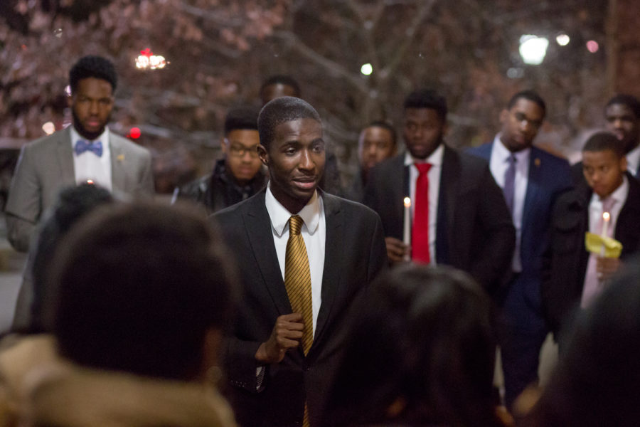 Junior communication and political science major Aaron Hill speaks in front of participants at Alpha Phi Alpha’s Martin Luther King Jr. Day candlelight vigil Monday night. (Photo by Thomas Yang | Visual Editor)