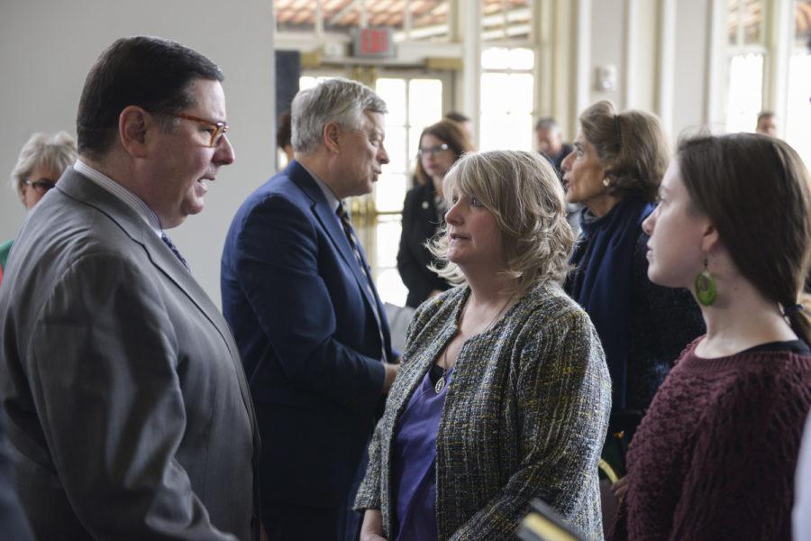 Mayor Bill Peduto (left) speaks with Michelle Lynam and her daughter Kimberly Lawther (right), as former Pitt Chancellor mark Nordenberg greets other guests behind them. (Photo by Chiara Rigaud | Staff Photographer)