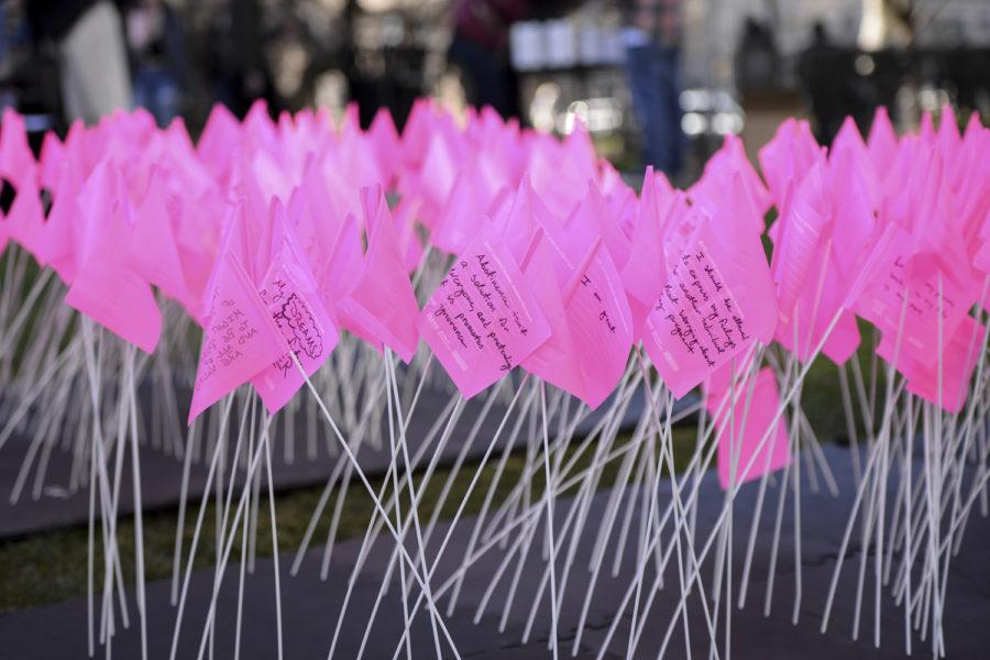 Pitt students write why they think birth control matters at the art installation, “My Body is My Own,” organized by Planned Parenthood Tuesday afternoon. (Photo by Sarah Cutshall | Staff Photographer)
