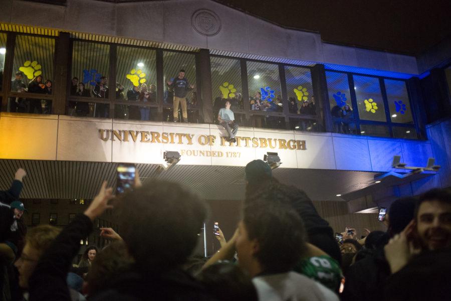 Students climb on the skybridge over Forbes Avenue after the Eagles Super Bowl win. (Photo by Thomas Yang / Visual Editor) 