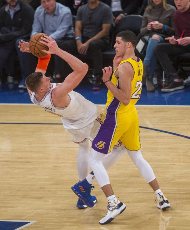 The Los Angeles Lakers’ Lonzo Ball (2) trips up the New York Knicks’ Kristaps Porzingis at Madison Square Garden in New York Tuesday, Dec. 12, 2017. The Knicks won, 113-109, in overtime. (Howard Simmons/New York Daily News/TNS)