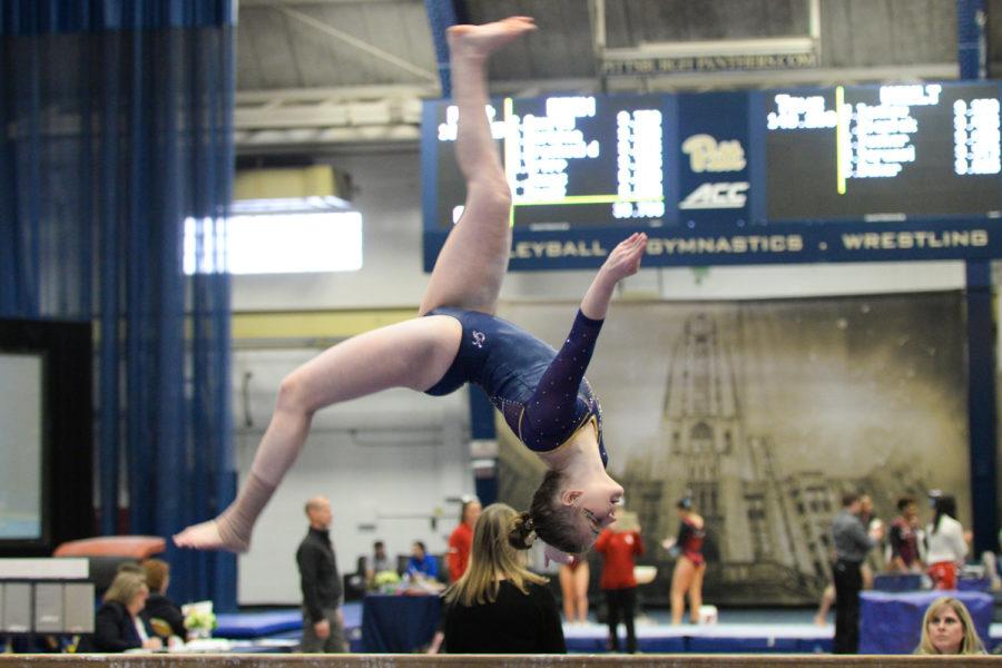 Sophomore Lucy Jones completes a back aerial while competing on beam during Saturday’s quad meet at Pitt. (Photo by John Hamilton | Managing Editor)