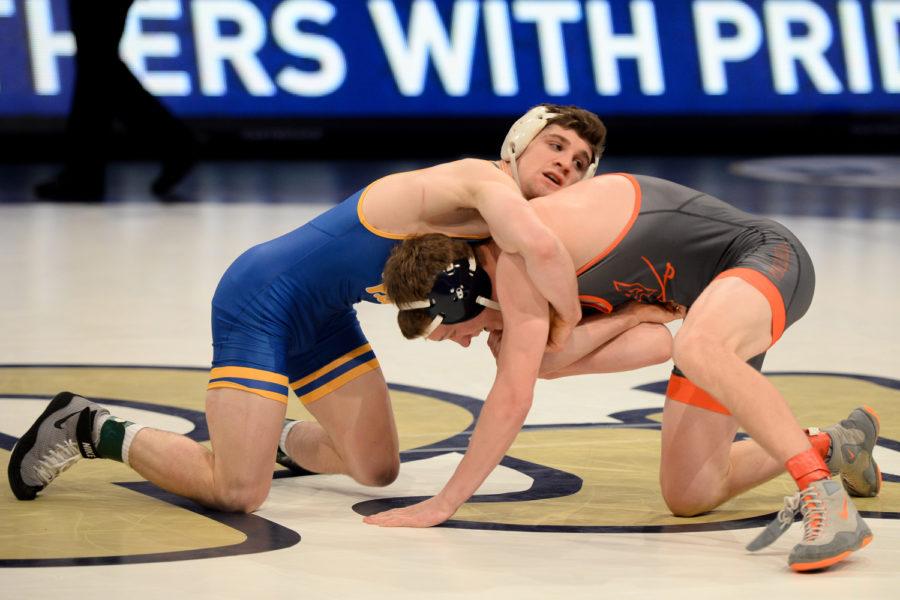 Senior Dom Forys grapples with his opponent during Pitt’s 28-9 victory over Virginia Friday night. (Photo by Chiara Rigaud | Staff Photographer)