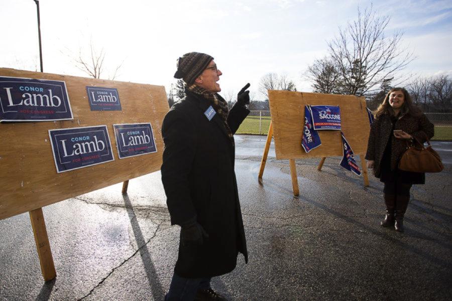 Supporters campaign for Democrat candidate Conor Lamb and Republican candidate Rick Saccone. Libertarian Party candidate Drew Miller went largely unnoticed during Tuesday’s special election. (Photo by John Hamilton | Managing Editor) 