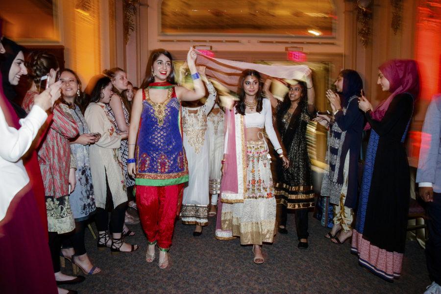 Friends hold a sheer tapestry over the head of Kamya Menon, the bride in the Pitt Pakistani Student Association’s Mock Shaadi event. (Photo courtesy of Jorge Santiago) 