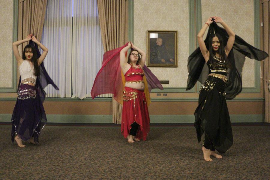 Xinyu Li (left), a senior majoring in microbiology, Victoria Wright, a junior majoring in ecology and evolution, and Ying-Tung Chou (right), a junior majoring in applied developmental psychology, represent Panther Belly Dancers and perform a traditional belly dance at the A Night in Beirut event in the William Pitt Union Monday night. (Photo by Isabelle Glatts | Assistant Visual Editor) 