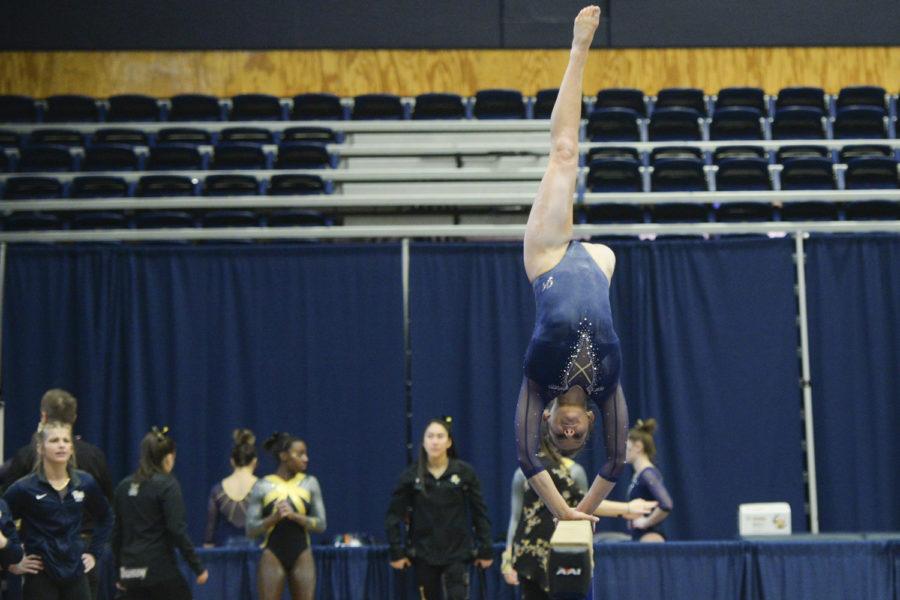 Catie Conrad, a senior, was the leading gymnast on bars for Pitt’s gymnastics team this year. Pictured above is Conrad on beams. (Photo by John Hamilton | Managing Editor) 