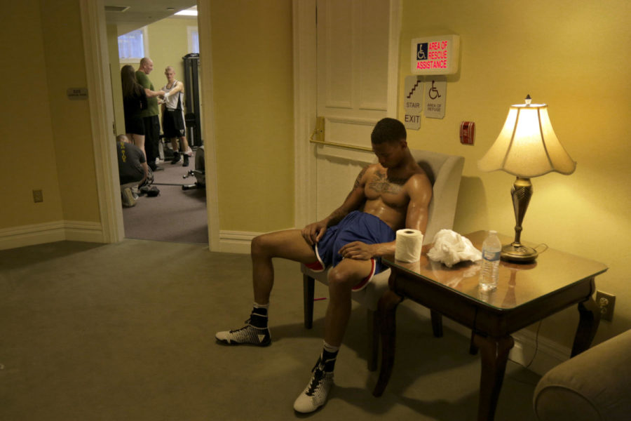 Gary Jackson, from Baldwin, recovers in the makeshift locker rooms in the basement of Priory Hall after losing his amateur boxing match. (Photo by Theodore Schwarz | Staff Photographer) 