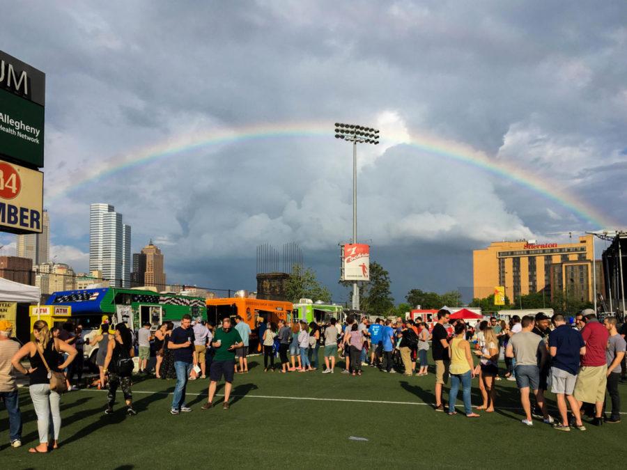 After an afternoon shower at the Highmark Stadium in Station Square, a rainbow stretches across the second annual Pittsburgh Taco Festival. (Photo by Delilah Bourque | Staff Writer)