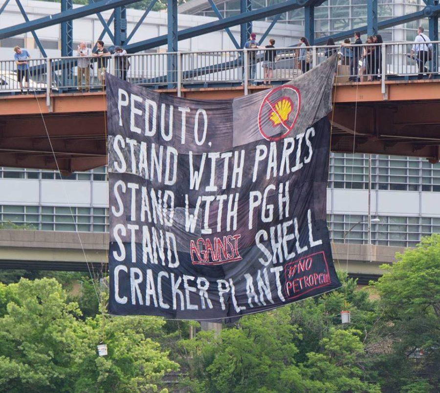 Free the Planet, an environmental organization at Pitt, organized Friday morning’s banner drop off of Smithfield Street bridge in protest of the construction of Beaver County’s ethylene cracker plant. (Photo courtesy of Mark Dixon)