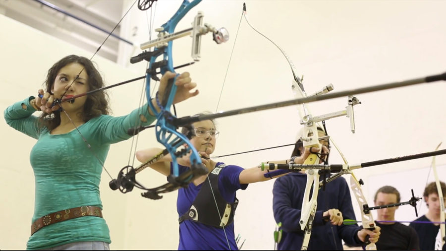 Kira Zack (left) practices with Pitt’s archery team during the 2017-18 school year. (Photo by Chris Preksta courtesy of Julia Lam)