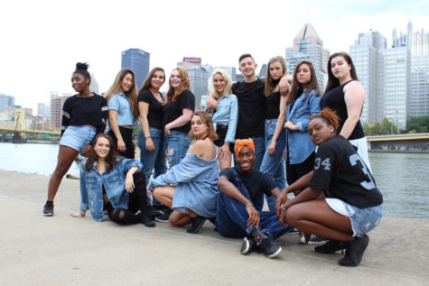 The hip-hop ensemble Controlled Chaos poses in black and denim outfits for a photoshoot. The group currently has 10 full-time members. (Photo courtesy of Mia Krawczel)