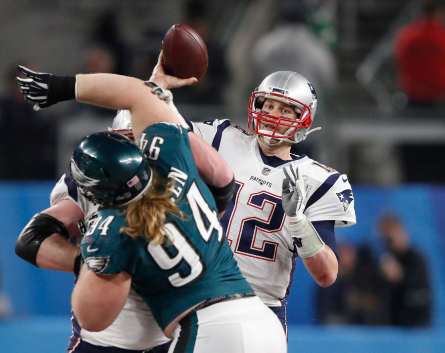New England Patriots quarterback Tom Brady (12) throws a pass during Super Bowl LII as the Philadelphia Eagles Beau Allen (94) applies pressure Feb. 4, at U.S. Bank Stadium in Minneapolis. (Carlos Gonzalez/Minneapolis Star Tribune/TNS)