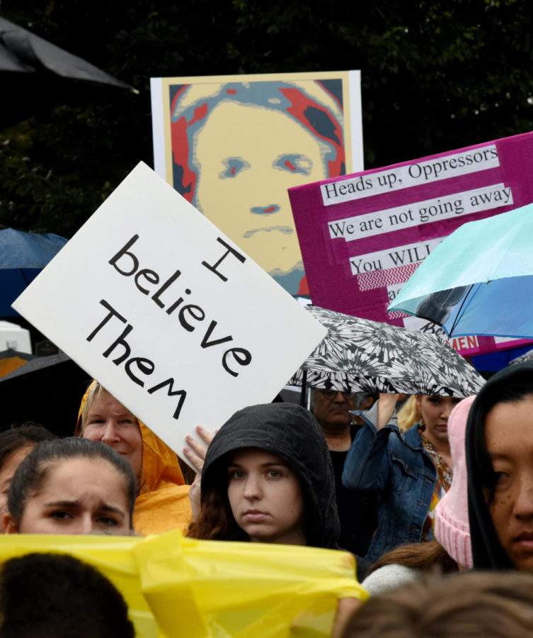 Demonstrators opposed to the Supreme Court nominee Brett Kavanaugh hold signs in front of the Supreme Court in Washington, D.C., U.S., on Sept. 27, 2018. (Olivier Douliery/Abaca Press/TNS)
